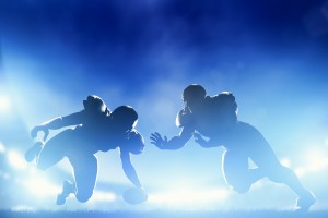 American football players in game, touchdown. Night stadium lights